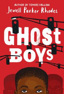 The book cover for Ghost Boys by Jewell Parker Rhodes, which has a red cover with the title "Ghost Boys", traffic lights, and the top of a young African American boy's head with his eyes looking up towards the sky.