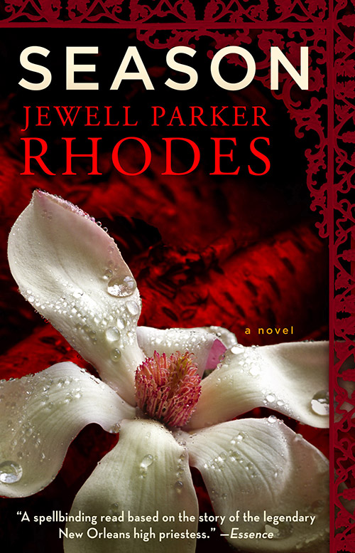 The book cover of Seasons by Jewell Parker Rhodes, has a white flower with red border details around the edge of the book.